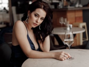 A sexy woman is drinking Champagne