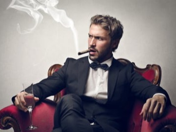 A handsome boss is sitting on the sofa